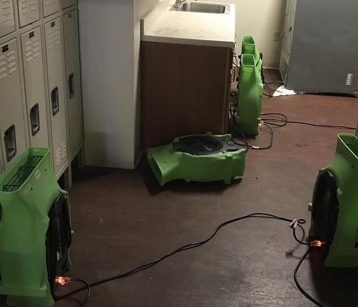 locker room with green air movers. 
