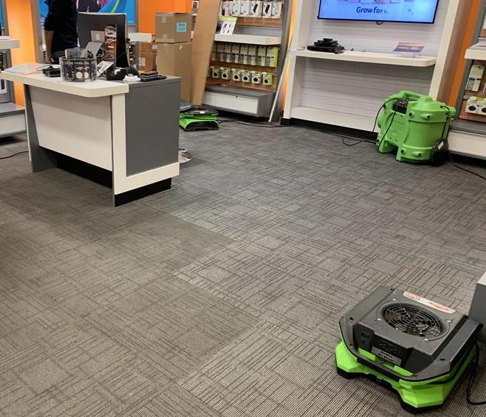 Green air movers on a carpet floor. 