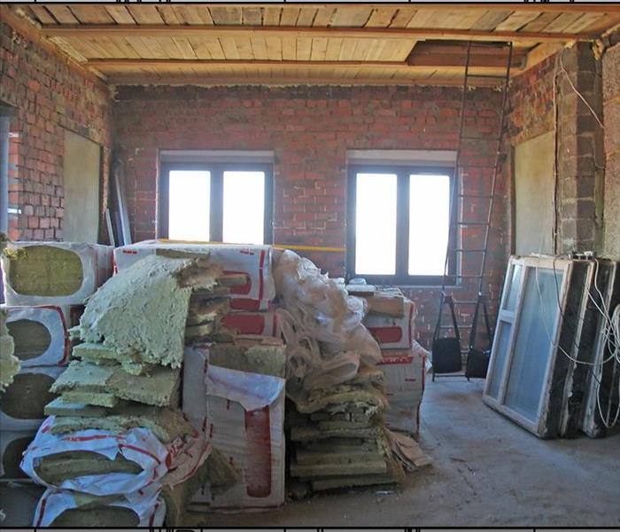 Room with brick walls and insulation stacked on the ground