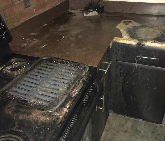 Burnt stove, oven, and countertop. 